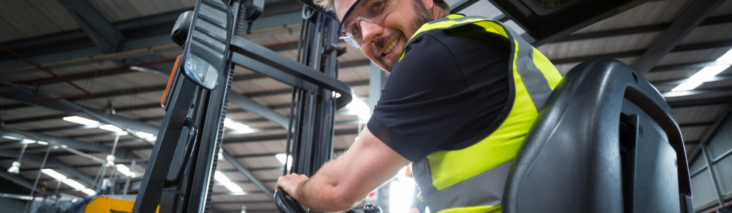 Portrait of smiling factory worker driving forklif 2021 08 28 17 19 59 utc